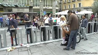 Barren blonde in strait jacket in public